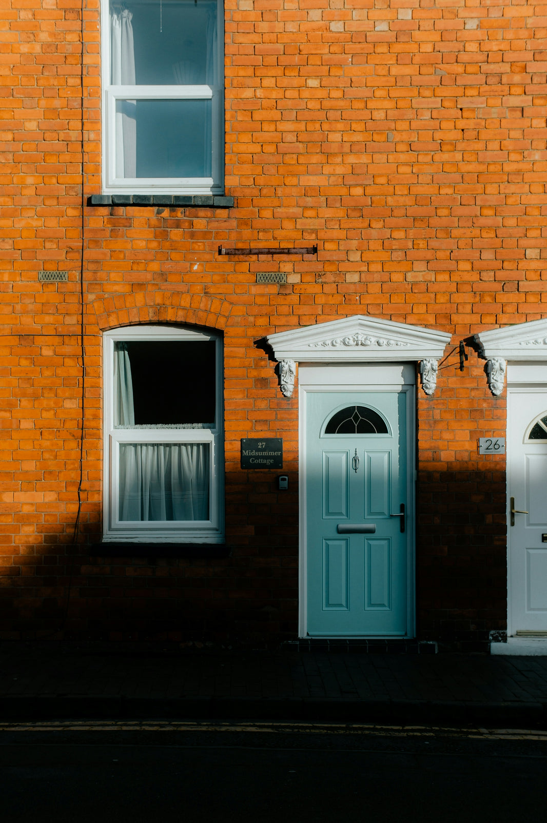 a brick building with three doors and windows