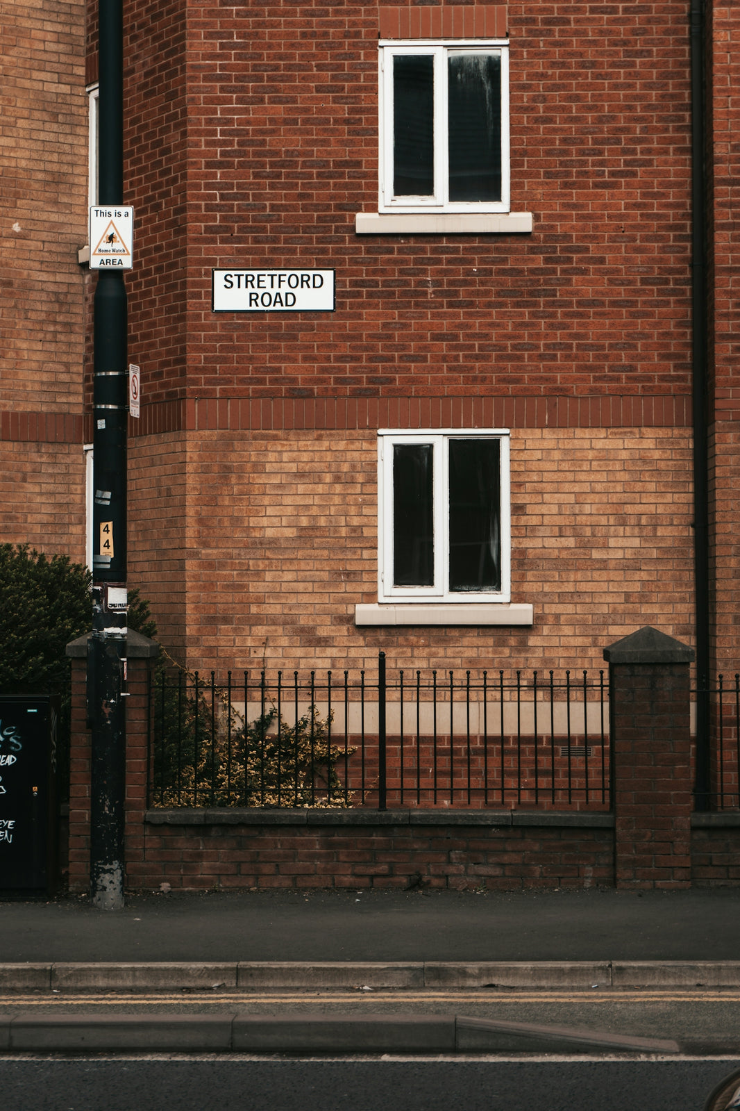 a brick building with a street sign on the side of it
