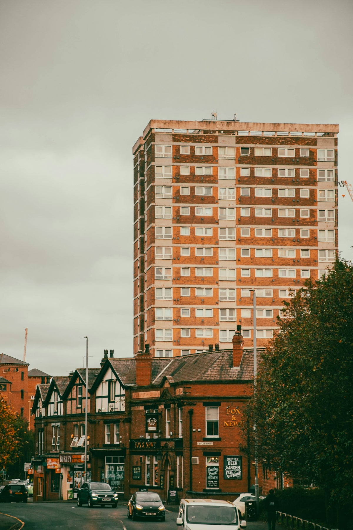 a tall brick building sitting on the side of a road